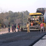 Labourers busy in construction work of Park Road with the help of heavy machineries during development work in the city.