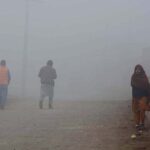People on the way during dense fog engulfs the whole city during morning time.