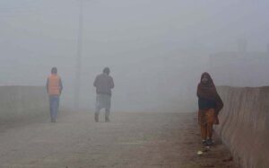 People on the way during dense fog engulfs the whole city during morning time.