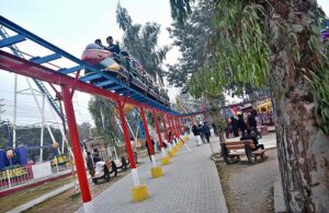 Children enjoying different swings at Public Park, Murree Road.