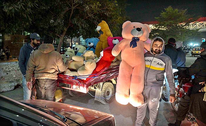 Vendor displaying teddy bear to attract the customers at Shamsabad.