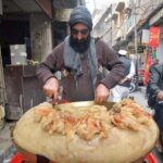 Vendor displaying traditional food item locally called "Mukhadi Halwa" to attract the customers at Qissa Khawani area