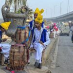 Traditional folk artists at roadside setup waiting to be hired for wedding ceremony