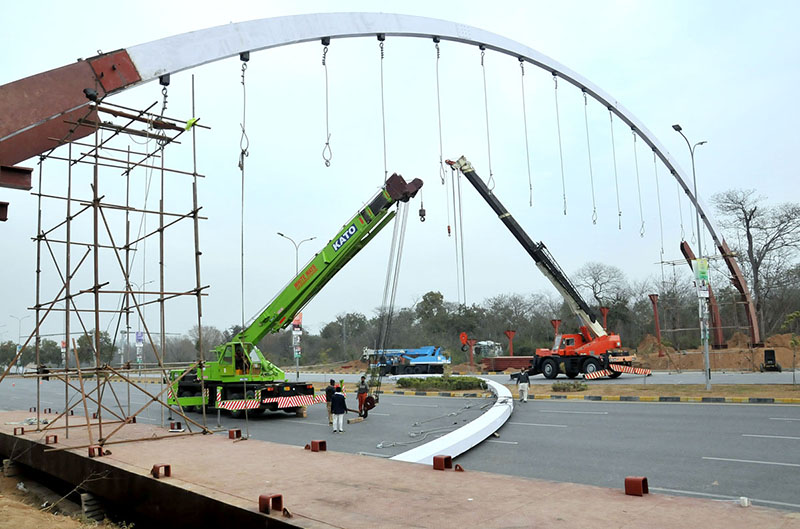 CDA workers busy installing pedestrian bridge with the help of cranes at Srinagar Highway in the Federal Capital CDA workers busy installing pedestrian bridge with the help of cranes at Srinagar Highway in the Federal Capital