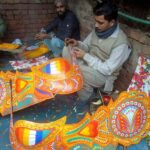 Workers busy making transport bus decoration items at their workplace