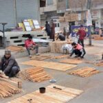 Workers busy in preparing election posters of the different parties and candidates at their workplace ahead of the upcoming General Elections-2024
