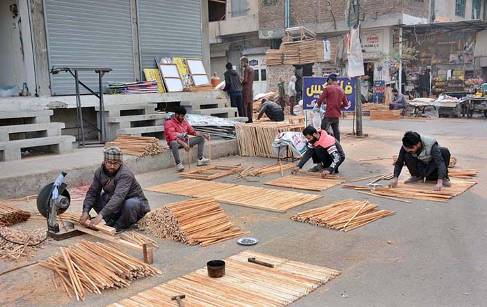 Workers busy in preparing election posters of the different parties and candidates at their workplace ahead of the upcoming General Elections-2024