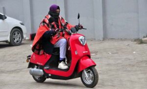 A female on the way while riding scooty at Stadium Road