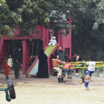 Children enjoy swings at Local Park in the city