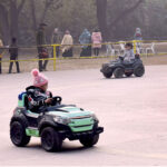 Children enjoying car riding at Gulshan-e-Iqbal Park
