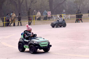 Children enjoying car riding at Gulshan-e-Iqbal Park