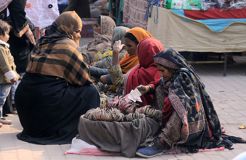 Women vendors selling bangles on roadside at Shamsabad