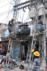 WAPDA staffers busy in repairing power transformer at Cycle Market.