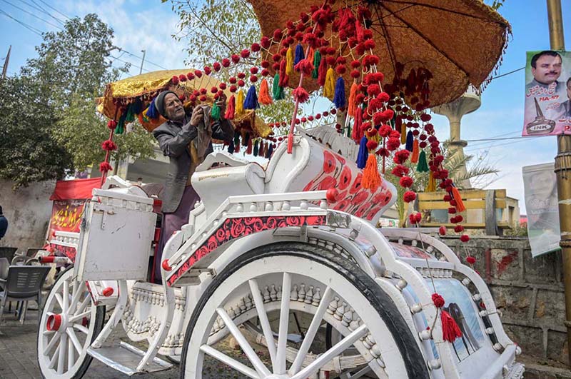 A worker busy in decorating horse cart to be hired for wedding ceremony