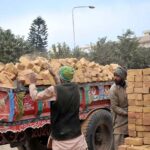 Labourers busy loading bricks on tractor trolley at f-11 Margala Road