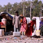 Gypsy family busy with their routine work outside huts at Makki Shah Area