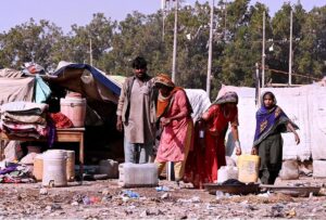 Gypsy family busy with their routine work outside huts at Makki Shah Area