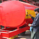 A worker busy in paint on the tanker body at his workplace