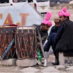 Traditional drummers sitting on roadside waiting for clients to get hired for functions at F-11 Margala Road