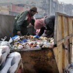 Gypsy youngsters searching valuables from garbage