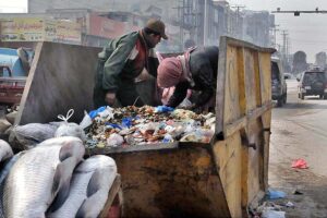 Gypsy youngsters searching valuables from garbage