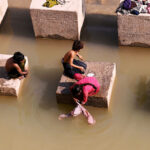 Gypsy family busy washing the clothes at Pinyari Canal