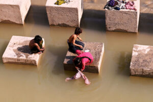 Gypsy family busy washing the clothes at Pinyari Canal