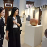 Visitors watching traditional pottery and ceramic pieces displayed in Exhibition 'Yakishime, Earth Metamorphosis' at SBP Museum