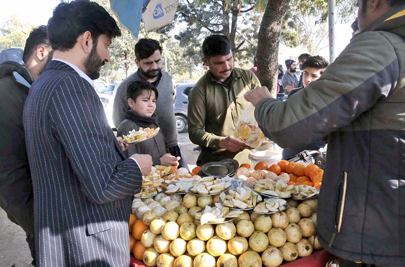 A vendor selling guava and orange to customers at Aabpara in Federal Capital