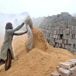 A labourer busy in his work as thick fog engulfs the city during morning time.