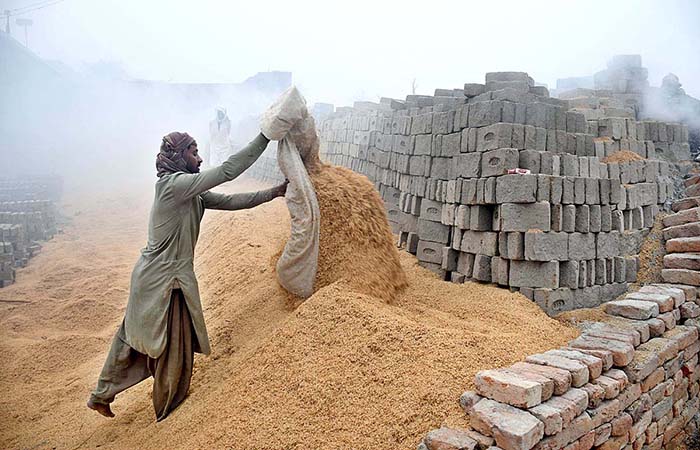 A labourer busy in his work as thick fog engulfs the city during morning time.