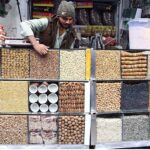 A vendor displaying dry fruits to attract the customers at Pakistani Chowk.