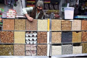A vendor displaying dry fruits to attract the customers at Pakistani Chowk.