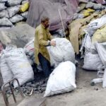 A vendor selling coal sacks as per increased demand in winter season.
