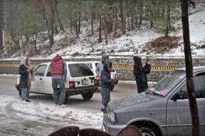 People capture the moment with their cell phones during first snowfall of the season.