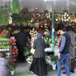 Woman purchasing artificial flowers for decoration at H-9 weekly bazar.