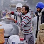 A vendor selling "Rice Pulao" on his hand cart setup.