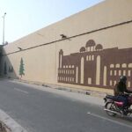 Worker busy paint on wall of 7th Avenue Underpass in the Federal Capital.