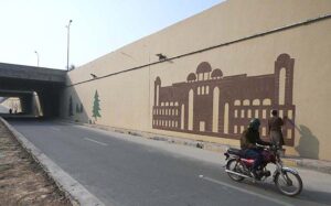 Worker busy paint on wall of 7th Avenue Underpass in the Federal Capital.