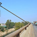 A view of electric light pole fallen on the flyover at Tando Yousuf road