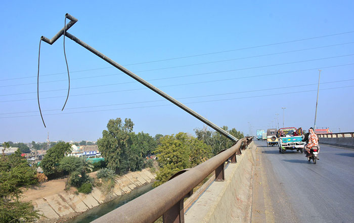 A view of electric light pole fallen on the flyover at Tando Yousuf road