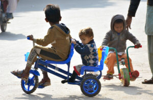 Children enjoying bicycle riding on the road.