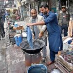 Workers busy in dyeing duptta for customers at Commercial Market.