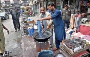 Workers busy in dyeing duptta for customers at Commercial Market.