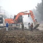 Heavy machinery being used during road construction work at Sargodha Road.