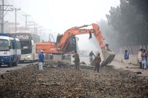 Heavy machinery being used during road construction work at Sargodha Road.