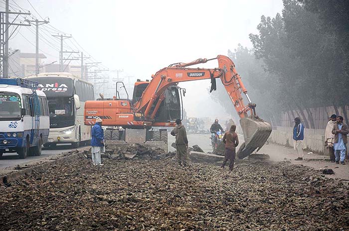Heavy machinery being used during road construction work at Sargodha Road.