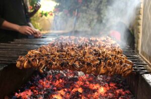 A vendor preparing traditional food item for customers at KhanaPul