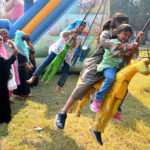 Children enjoying swing in a local Park at Latifabad