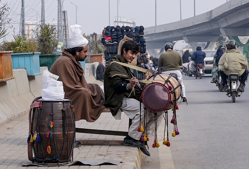 Traditional drummers sitting on the roadside while waiting for clients to be hired for functions at Marrir Chowk neighborhood